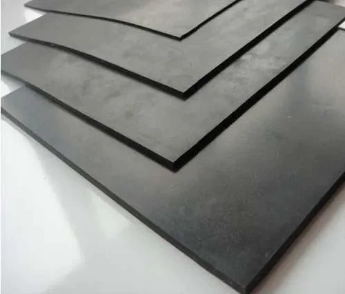 Pilha de lençóis de borracha preta com superfície lisa, dispostas em um padrão escalonado sobreposto sobre um fundo branco.